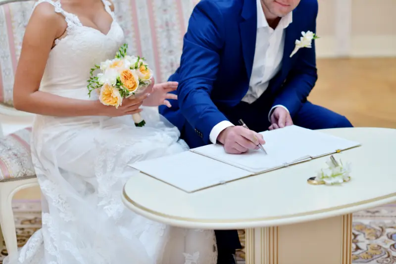 Bride and groom signing – antenuptial contract registration